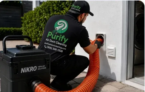 Purify technician connecting a negative-air hose to an exterior wall vent